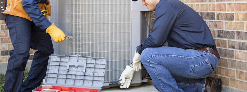 HVAC Technician installing outdoor HVAC unit