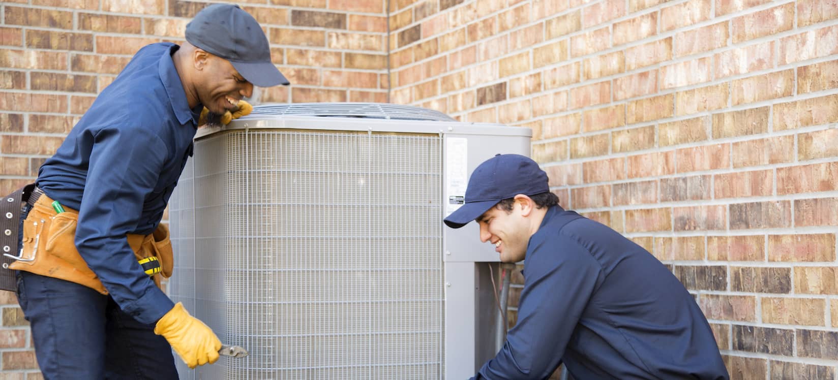 HVAC Technician installing outdoor HVAC unit